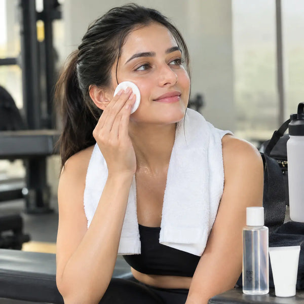 A women is cleansing her face after Post-Workout in Gym or a Match